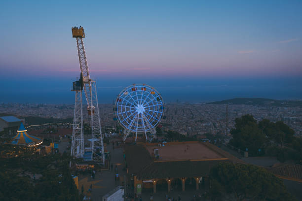 The amusement park of Tibidabo mountain at sunset with a view of Barcelona city
