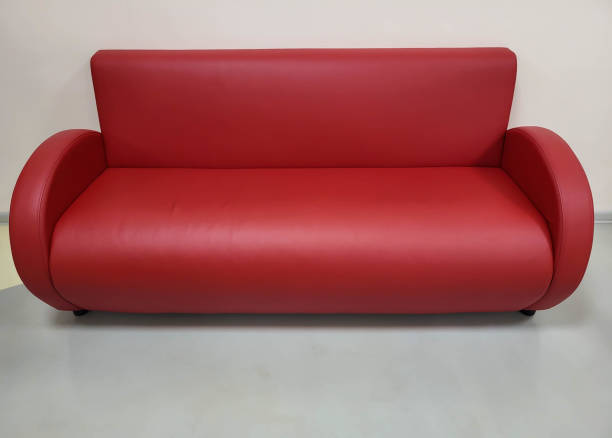 istock A small beautiful red sofa for relaxing made of eco-leather. 2037480927