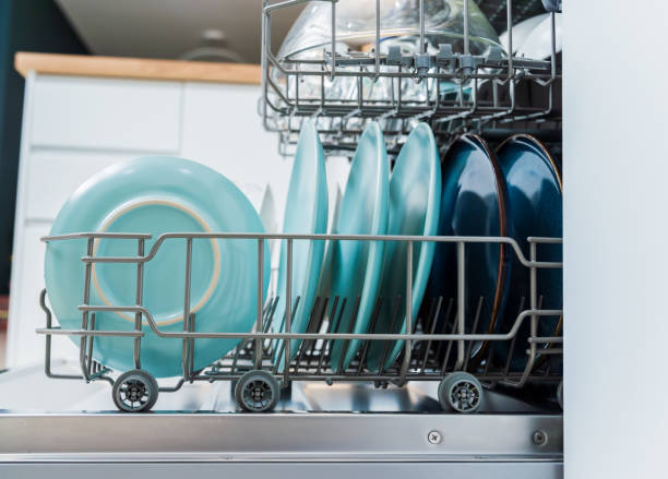 istock The white kitchen and opened dishwasher with clean dishes 2037482001