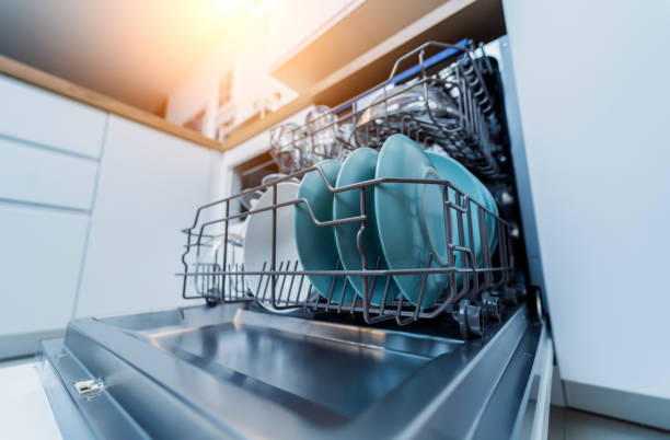 istock The white kitchen and opened dishwasher with clean dishes 2037483089
