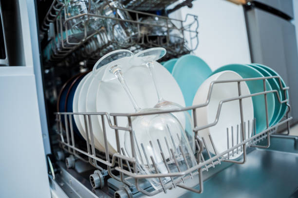 istock The white kitchen and opened dishwasher with clean dishes 2037484151