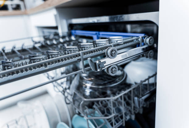 istock The white kitchen and opened dishwasher with clean dishes 2037485746