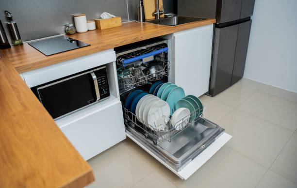 istock The white kitchen and opened dishwasher with clean dishes 2037496029