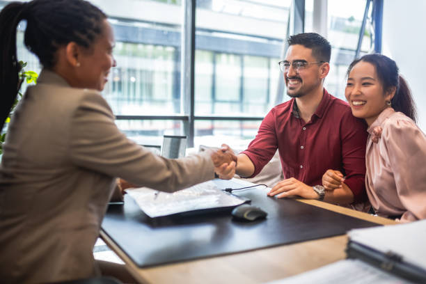 istock African American financial advisor analyzing documents with her clients in a meeting in the office. 2037518955