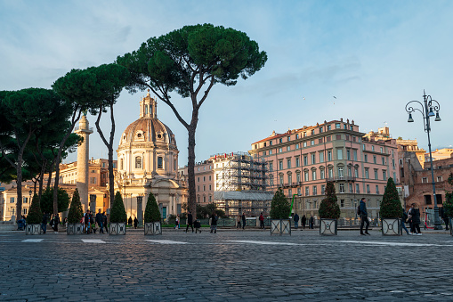 Rome, Italy - December 22, 2022: Santa Maria di Loreto church stands majestically among Rome's pines with the bustling city life around it