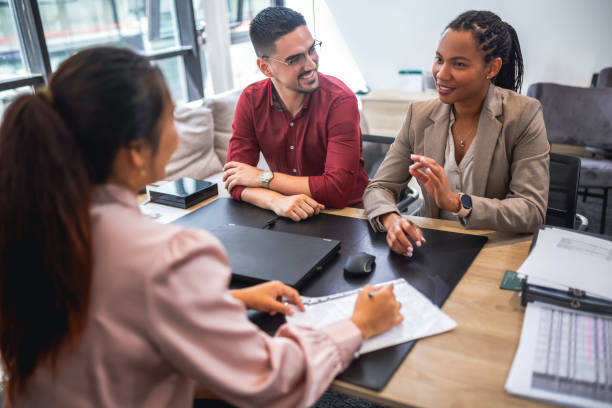 istock Financial advisor analyzing documents with her clients in a meeting in the office. 2037524654