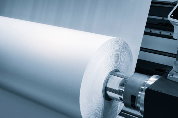 istock Automatic polyethylene plastic bag production machine with lighting effect. Close-up of the roller of the plastic bag production machine in the light blue scene. product packaging concept 2037544501