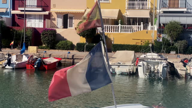 French and Spanish yacht ensign flags waving with the wind