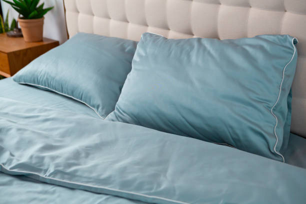 istock wrinkled blue cotton bed linen blanket and pillows 2037555297