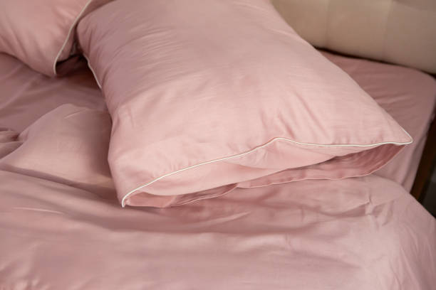 istock pink cotton bed linen pillows close up 2037556327