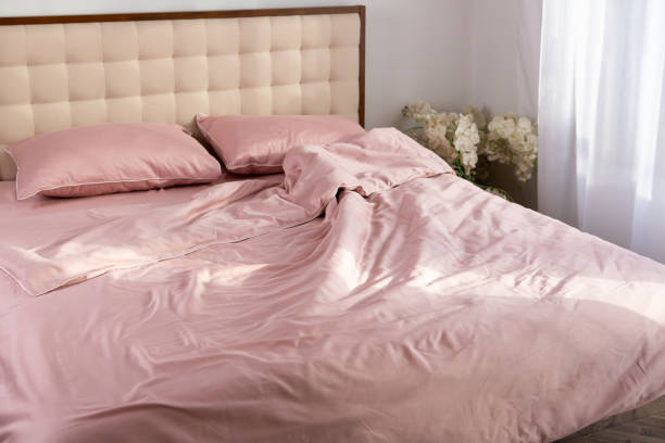 istock wrinkled pink cotton bed linen pillows morning 2037556330