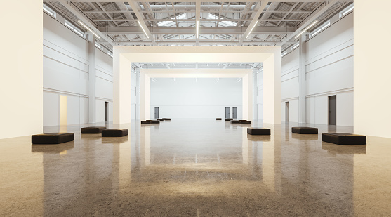 Large open space warehouse gallery with blank white walls in row, concrete floor. Soft seats for guest to watch or relax. Industrial concrete loft with doors for art exhibition. 3D rendering