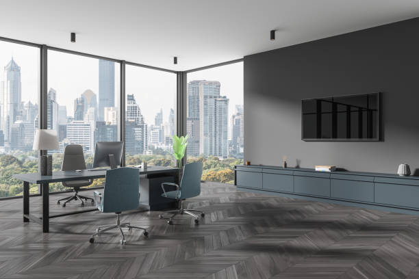 istock Corner view of office interior with workspace near window, pc computer 2037562114