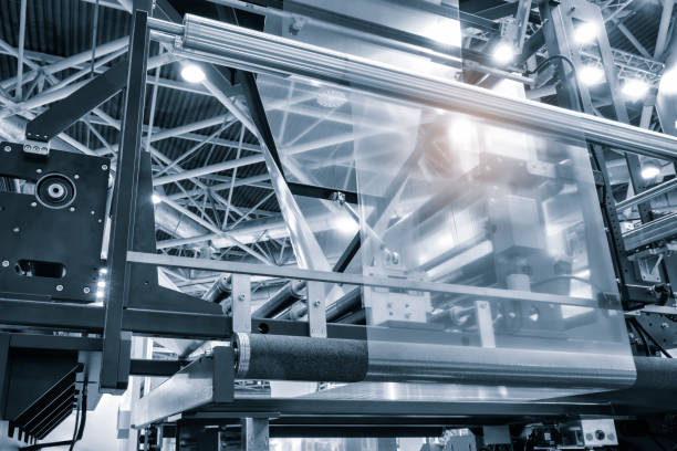 istock Automatic polyethylene plastic bag production machine with lighting effect. Close-up of the roller of the plastic bag production machine in the light blue scene. product packaging concept 2037592217