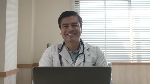 Doctor is working with laptop at hospital.
