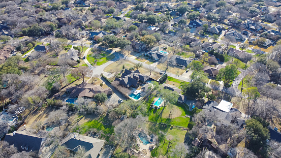 Expensive suburban neighborhood, aerial view low density housing area small number of luxury two story house with circular driveway, swimming pool, large backyard, subdivision sprawl Dallas, TX. USA