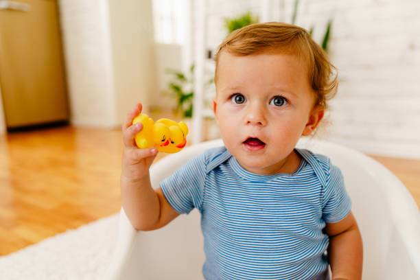 istock Toddler playing with  rubber duck toy at home 2037608986