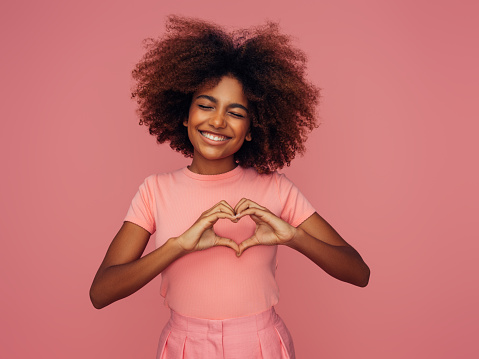 Photo of cheerful curly girl with positive emotions