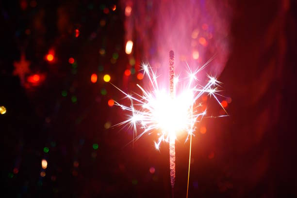 istock Sparkling sparklers at night. Bright Christmas background. A festive event. 2037638438