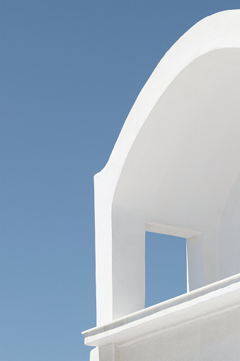 minimalistic white building with curves under clear sky in Oia, Santorini, Greece