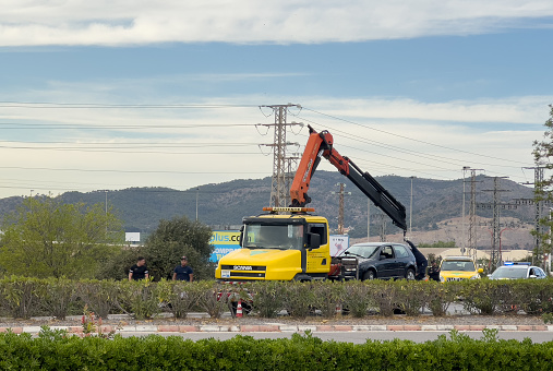 Recovery Truck Tows a car after crash. SCANIA Emergency Rescue Wrecker Tow Truck coach car. Towing Vehicle. ars accident on freeway. Auto Car wreck on road. August 12, 2023, Spain, Sagunto