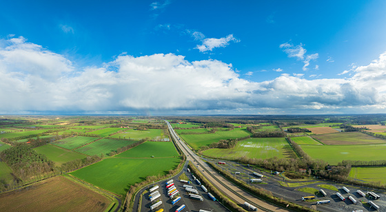 aerial view of rainclouds moving away over the German E30 highway. Below you see Waldseite-Nord parking place.