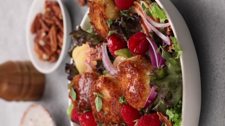 Fried goat cheese salad with raspberries and red onion