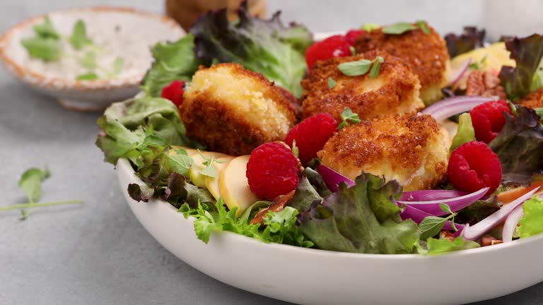 Fried goat cheese salad with raspberries and red onion