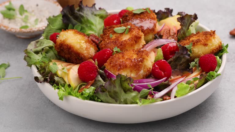 Fried goat cheese salad with raspberries and red onion