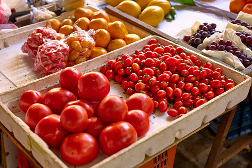 Fruits in traditional market in Taiwan. Fresh raw organic fruits closeup shoot. These fruits are good for healthy salad ingredient. Fresh red tomatoes and oranges, grape. Taiwan.