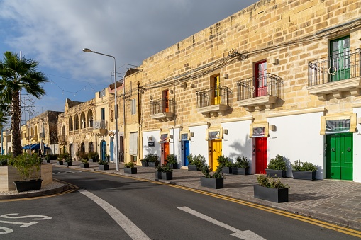 Marsaxlokk, Malta - 22 December, 2023: house front in downtown Marsaxlokk with colourful doors and French door balconies