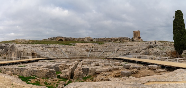 Syracuse, Italy - 28 December, 2023: panorama view of the Greek Theater in the Neapolis Archaeological Park in downtwon Syracuse