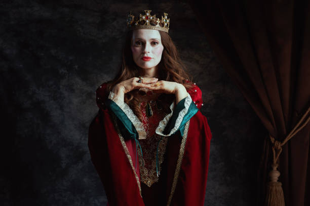 istock medieval queen in red dress with white makeup and crown 2037790016