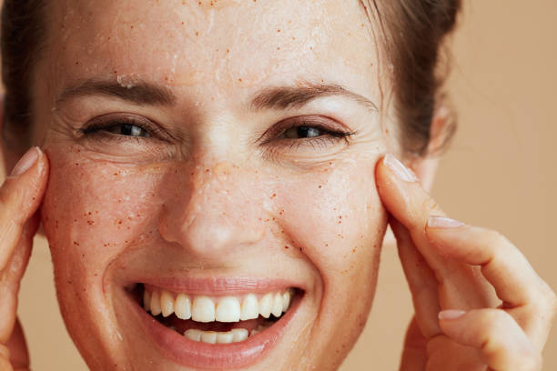 istock smiling young female with face scrub 2037790566