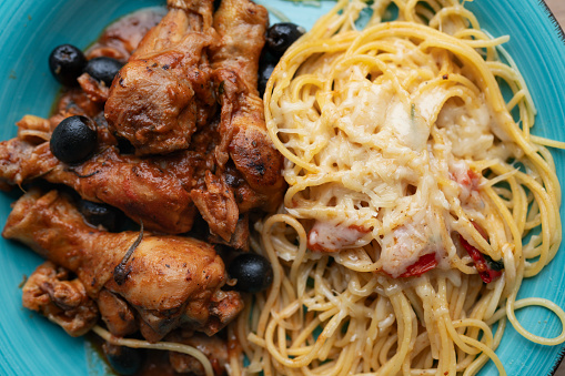 Chicken cacciatore with black olives, pepperoni, tomatoes, with italian spaghetti pasta. Italian food
