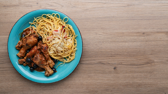 Chicken cacciatore with black olives, pepperoni, tomatoes, with italian spaghetti pasta. Italian food