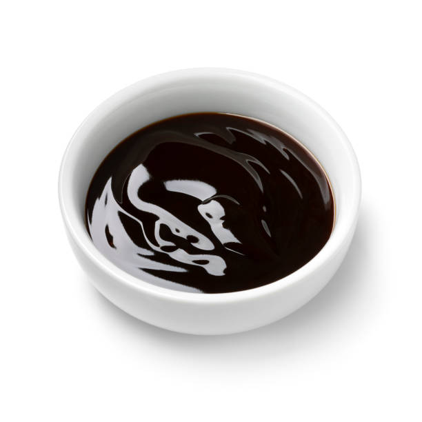 istock Single white bowl with oyster sauce on white background close up 2037813179