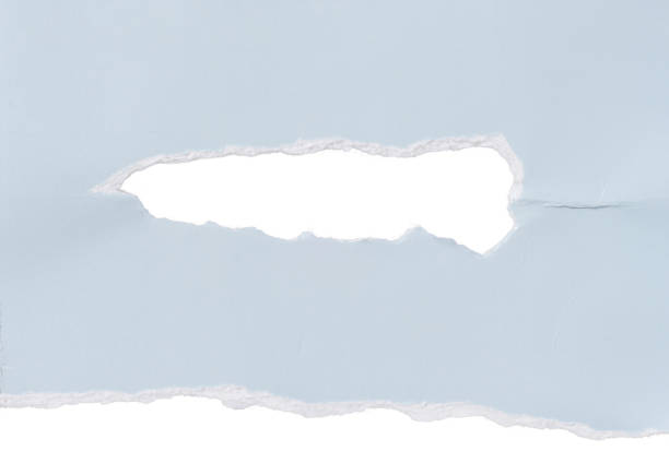 istock Torn piece of blue cardboard with a hole on an isolated background 2037815838