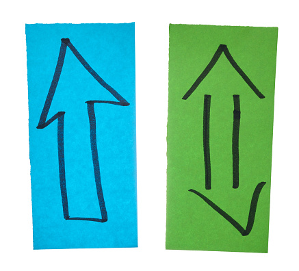 Two sheets of paper with arrows drawn with black marker on an isolated background