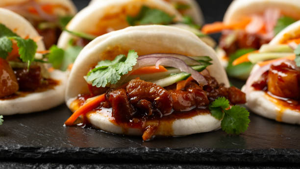 istock Bao buns with pork belly and vegetable. Asian cuisine 2037843639