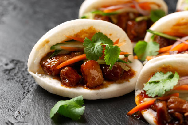istock Bao buns with pork belly and vegetable. Asian cuisine 2037843660