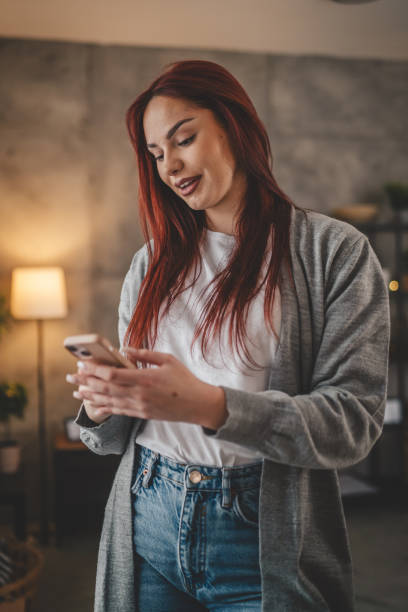 istock young woman at home use mobile phone sms texting or browse internet 2037846187