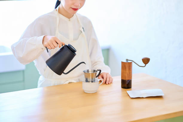 istock Young woman making coffee in the kitchen 2037861518