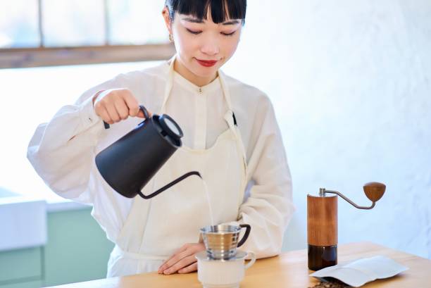istock Young woman making coffee in the kitchen 2037862048
