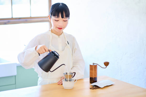 istock Young woman making coffee in the kitchen 2037862079