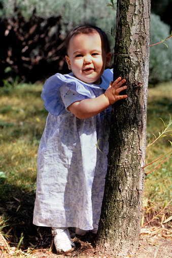 Baby girl and the tree in the moorland forest on 08-24-1991