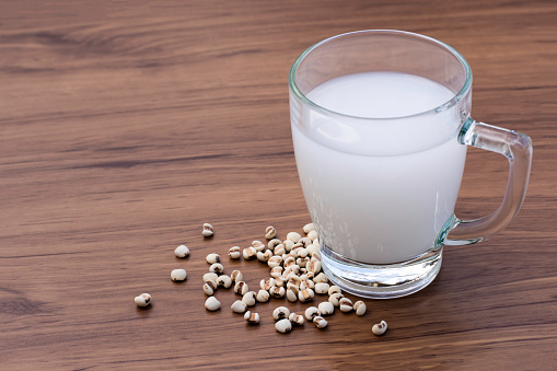 Millet milk and white Job's tears (Adlay millet or pearl millet) isolated on white background.