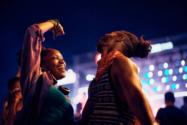 istock Young black couple having fun while dancing on open air summer festival at night. 2037882801