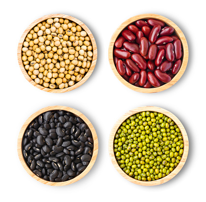 Assorted legumes in wooden bowl lentils, soybean and beans