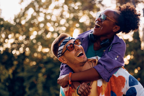 istock Happy man piggybacking his black girlfriend and having fun while going to summer music festival. 2037886503